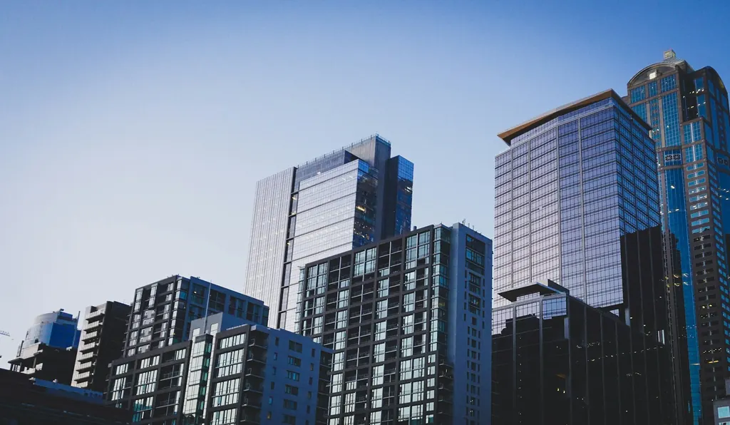 Modern glass residential towers against a blue sky