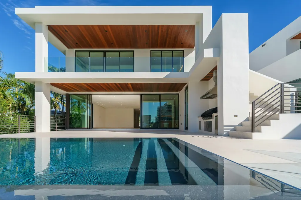 Luxury home with a covered terrace overlooking a pool